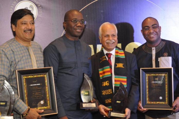 Mr. AK Mirchandani (2nd left) and management of Avnash Industries Ghana Limited, displaying the two awards