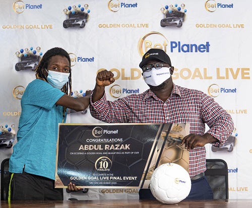 (From right) Mr. Sosthenes Galevo, Country Manager for Planet Sports Limited presenting the Golden Goal ticket to Abdul Razak