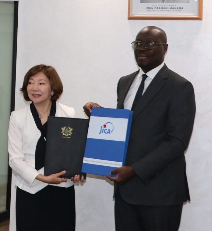 Miyazaki Katsura, Executive Senior Vice President of JICA, left with Ato Forson, Ghana's Finance Minister, right