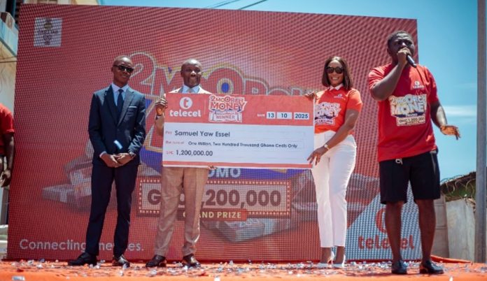 Rev. Samuel Essel receives the GH¢1.2 million cash prize as winner of the live grand draw to climax the Telecel 2Moorch Money promo
